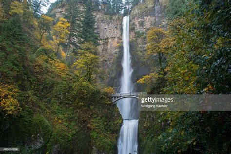 View Of Multnomah Falls With Foot Bridge In The Fall A Waterfall