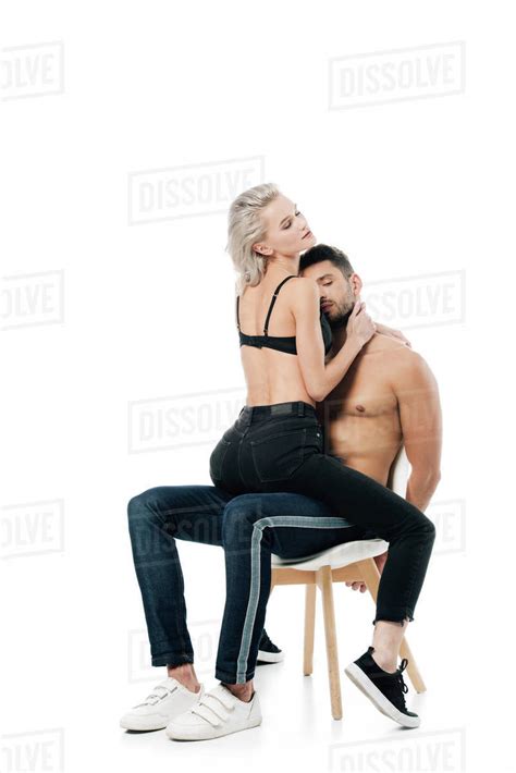 Passionate Couple Sitting On Chair And Embracing Isolated On White