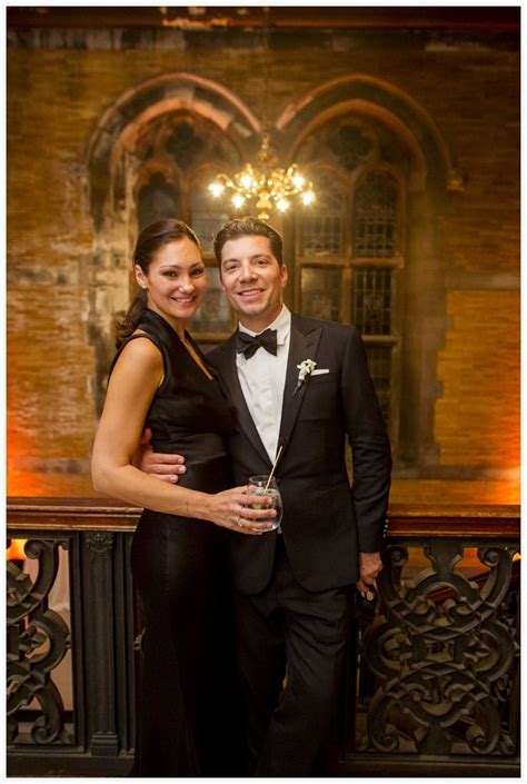 A Man And Woman In Formal Wear Posing For A Photo At An Event With