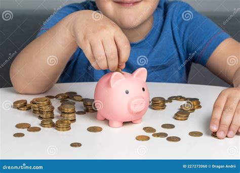 The Child Puts Coins In The Piggy Bank Stock Photo Image Of Years