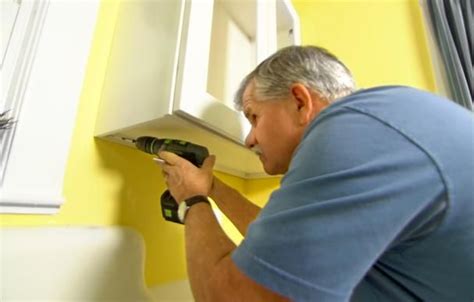 Applying adequate pressure isn't always easy when hanging a wall cabinet from below. How to Hang a Kitchen Wall Cabinet | Kitchen wall cabinets ...