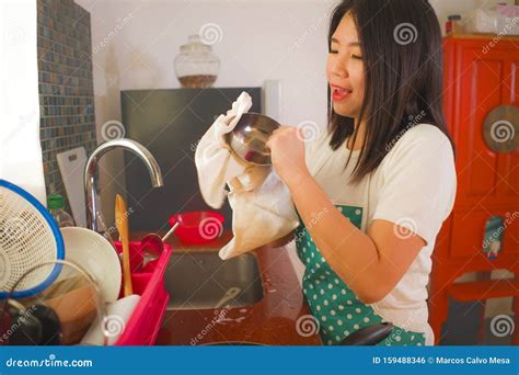 Young Beautiful And Happy Asian Chinese Woman In Apron And Rubber Glove