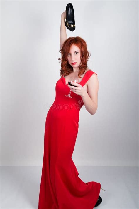 Beautiful Young Slim Red Haired Girl Wearing A Slinky Silk Red Dress