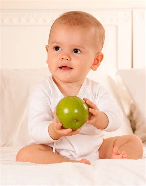Baby Manipulating Green Apple Stock Photo Image Of Caucasian