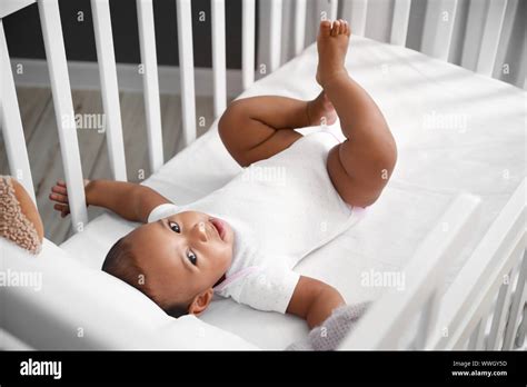Cute Little African American Baby In Crib Stock Photo Alamy