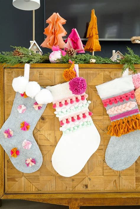 diy colorful pom and yarn holiday stockings christmas stockings diy christmas diy christmas
