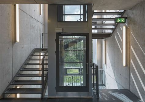 Metal Staircase Wrapped Around A Central Glass Lift Shaft In The Sport