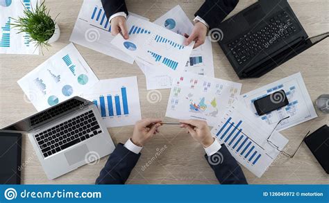 Managers Checking Business Diagrams Discussing Financial Report