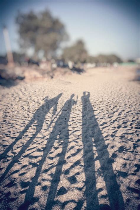 Shadows Of Three People On A Beach In Stock Image Colourbox