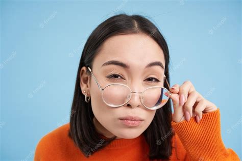 Free Photo Close Up Of Asian Woman In Glasses Thinking Staring At Camera With Thoughtful Face