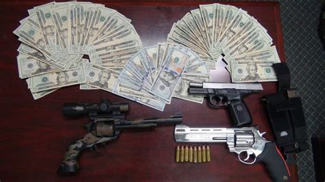 police seize loaded guns loads of cash in drug bust