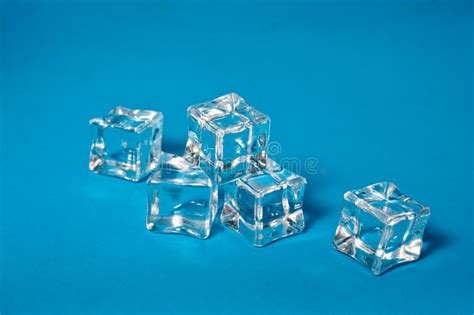Clear Ice Cubes For Cooling Drinks On A Blue Background Stock Photo