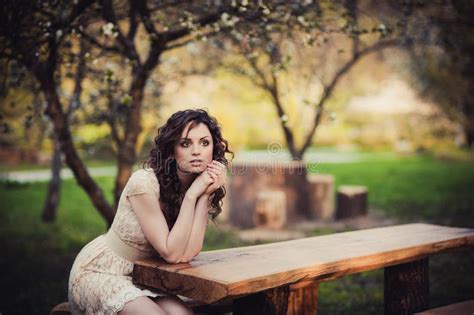 Brown Eyed Brunette Girl Sitting On A Bench Stock Photo Image Of