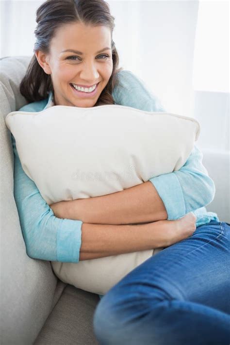 Smiling Woman Holding Pillow Sitting On Couch Stock Photo Image Of
