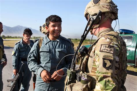 Us Army Staff Sgt Mark Reed Greets An Afghan Uniformed Policeman