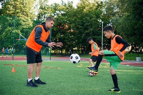 Premium Photo Soccer Coach Instructs Teen Players
