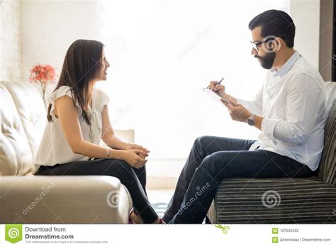 Hispanic Woman Talking To Her Therapist At Therapy Session Stock Photo