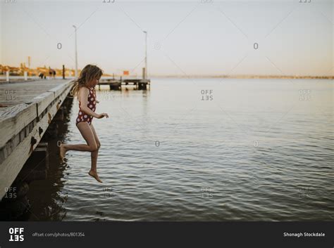 Girl Jumping Off The Jetty Into The River Stock Photo Offset Play Girl