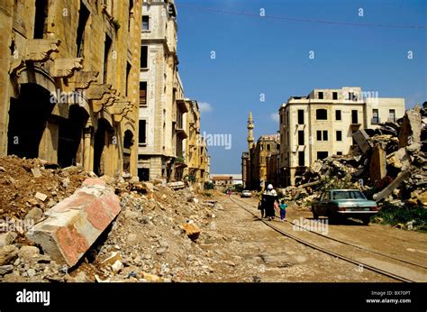 People Walking Past Buildings Destroyed By The Lebanese Civil War