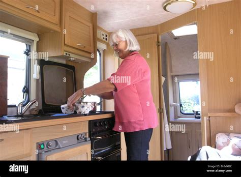 Senior Woman Cooking In Rv Caravan Stock Photo Alamy