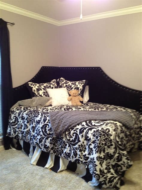 A Teddy Bear Sitting On Top Of A Black And White Bed