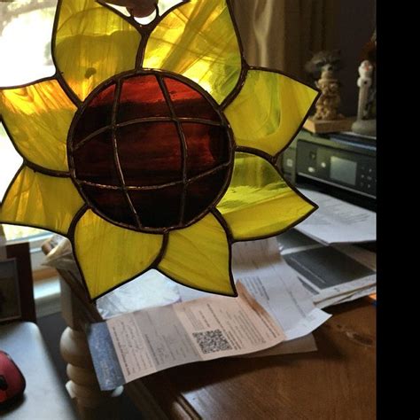 A Stained Glass Sunflower Hanging From A Window