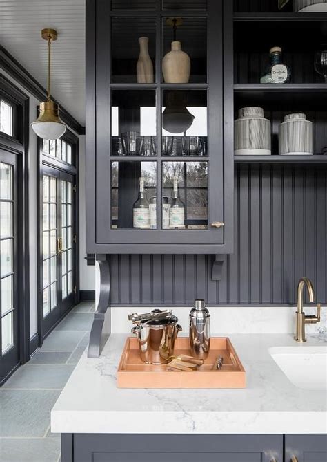 Metal kitchen island base without countertop materials. Black butlers pantry designed with black cabinets, black ...