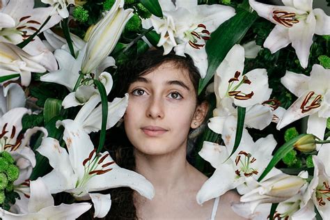 Headshot Of A Girl Among Lilies All Over Her Head Del Colaborador De