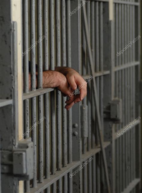 Mans Hands Behind Bars In Jail Or Prison — Stock Photo © Willeecole