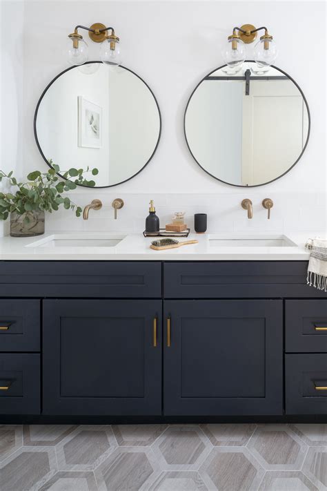 Navy Double Vanity Bathroom With Brass Fixtures And Round Mirrors