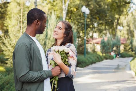 Man Giving Flowers For His Beautiful Girlfriend Stock Image Image Of Outdoors Park 109143499
