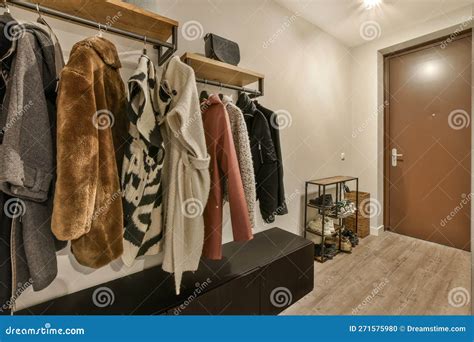 A Wardrobe With Coats And Jackets Hanging On A Rack Stock Photo Image
