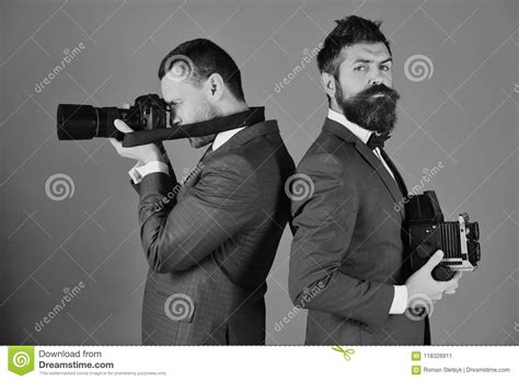 Photographers Working Men With Beards Hold Photo Cameras On Blue