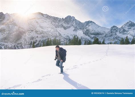 Man Walking Through Snow In Mountains Stock Photo Image Of People