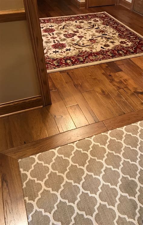 Entry Rug On Wood Floor And Carpet Inlaid Under A Wood Border In Next
