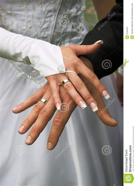 According to a tradition believed to have been derived from the romans, the wedding ring is worn on the left hand ring finger because there was thought. Wedding rings on fingers stock image. Image of rings ...
