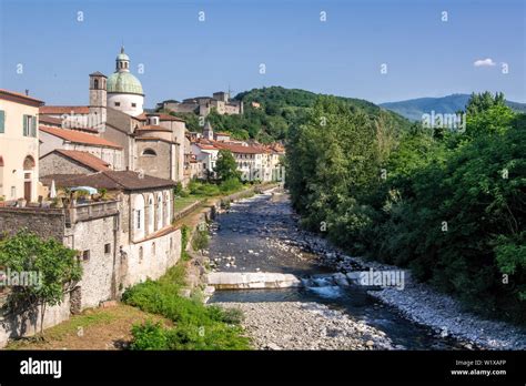 Tuscan Village Of Pontremoli With The Magra River In The Forefront And