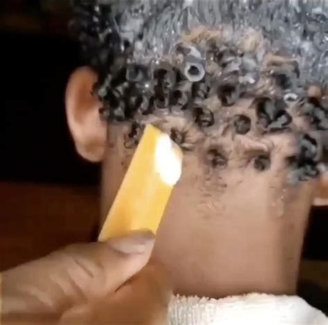 Afar Man Having A Traditional Hairstyle With A Stick To Make Curly Hair