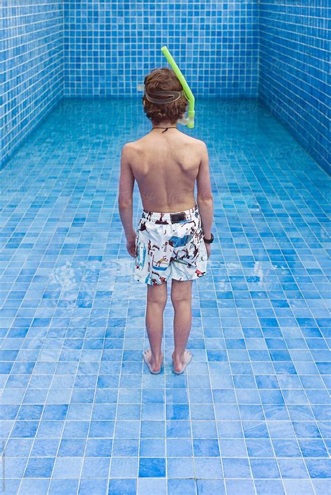 Boy With Snorkel In Empty Swimming Pool By Stocksy Contributor