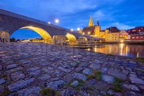 Regensburg Old Stone Bridge Over The Danube River At Night Light