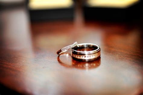 Artistic Engagement Ring Wedding Band Photo Captured On Dark Mahogony