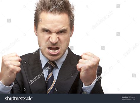 Closeup Angry Businessman Holding His Fists Into Camera Isolated On