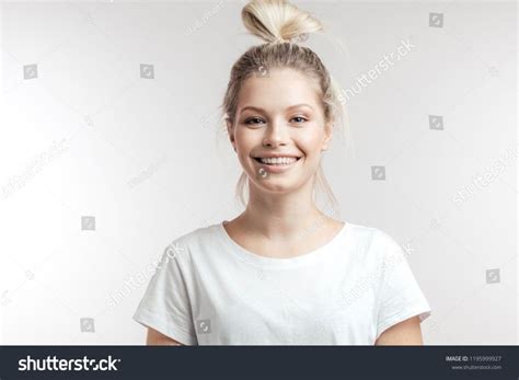 Attractive Caucasian Cheerful Female With Blonde Hair Tied In Bun