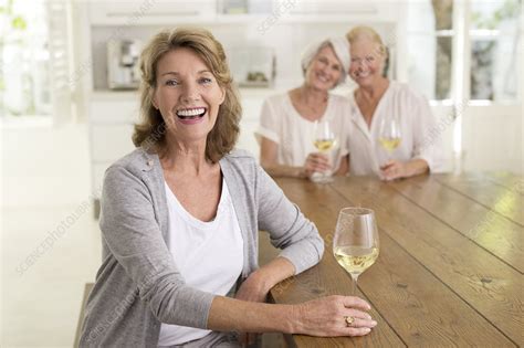 smiling senior women drinking white wine stock image f014 0857 science photo library