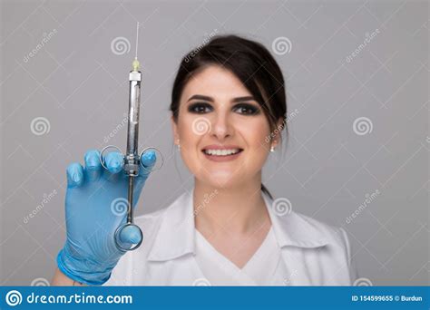 Closeup Photo Of Female Dentist Holding Oral Syringe Isolated Over The