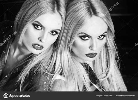 Sexy Young Pretty Girls Twin Sisters With Blond Hair Fashionable Makeup And Sexy Red Lips