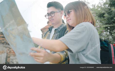 Traveler Asian Couple Direction And Looking On Location Map While Spending Holiday Trip At