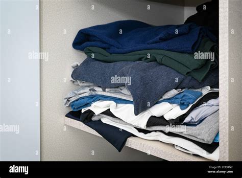 Clothes Messy Piled Up On The Closet Shelf Stock Photo Alamy