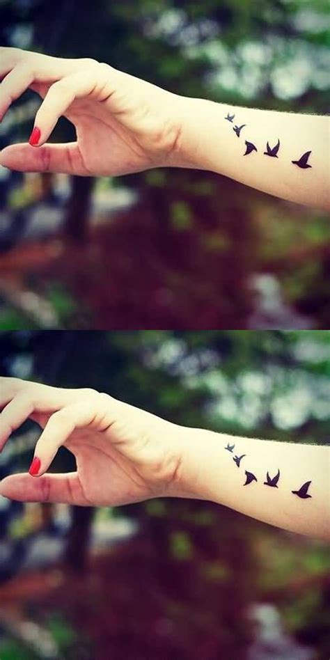 Two Hands With Birds Tattoo On Them