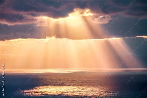 Rays Of Light After Rain Storm Seascape With Sun Reflections On Water